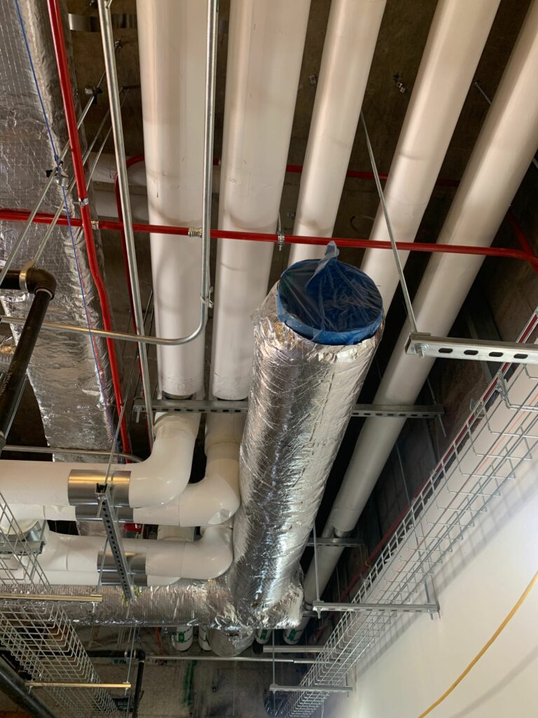 HVAC PROTECTION: Ducts and pipes are flushed, and openings are covered after installation