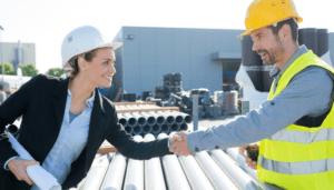 women in constrction shaking a mans hand